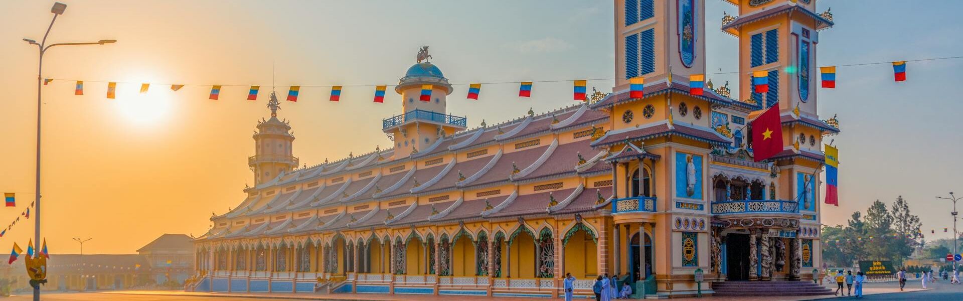 Cao Dai Temple’s vibrant architecture during a guided Cao Dai Tours experience with Legend Travel Group in Tay Ninh.